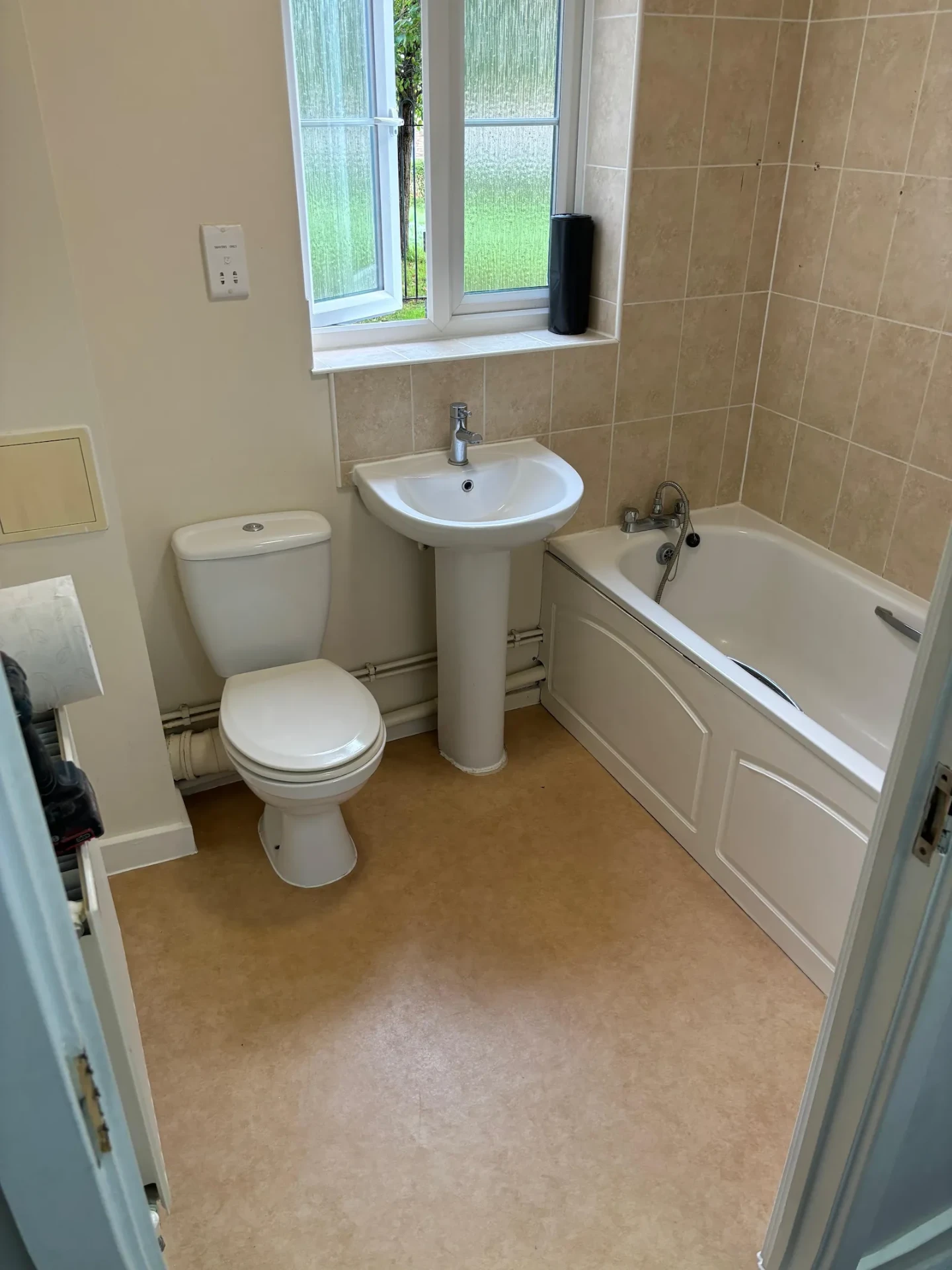 Basic beige bathroom in Emerson Park with a pedestal basin and standard bath before renovation