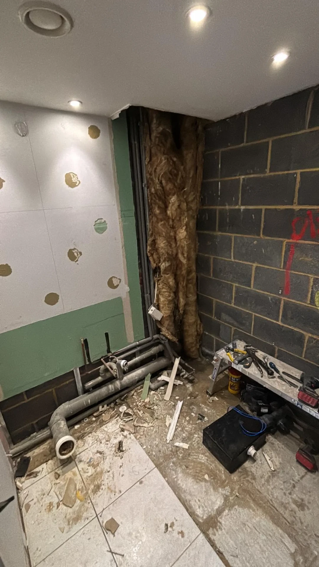 Bathroom in Hornchurch stripped to blockwork and exposed pipework before renovation