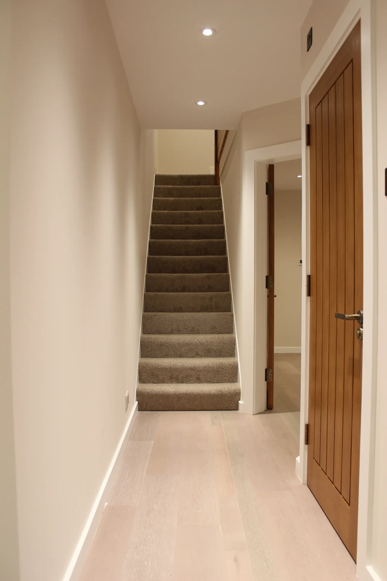 Bright ground-floor hallway looking towards the refinished staircase