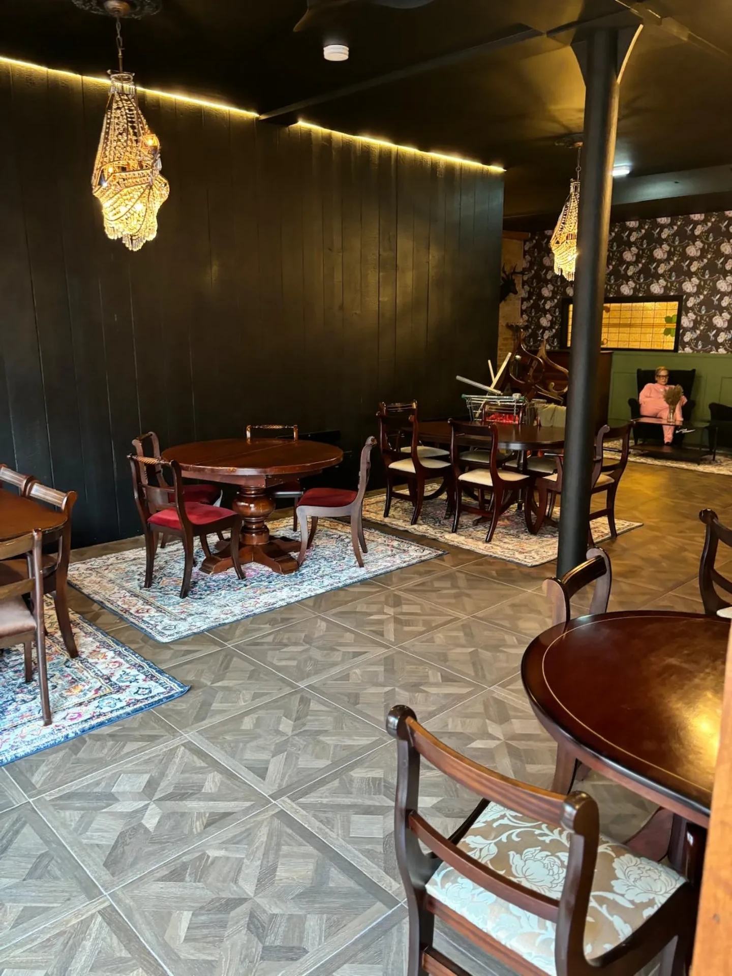 The same E1 unit after conversion by Bridgerose into a restaurant with dark panelled walls and chandeliers
